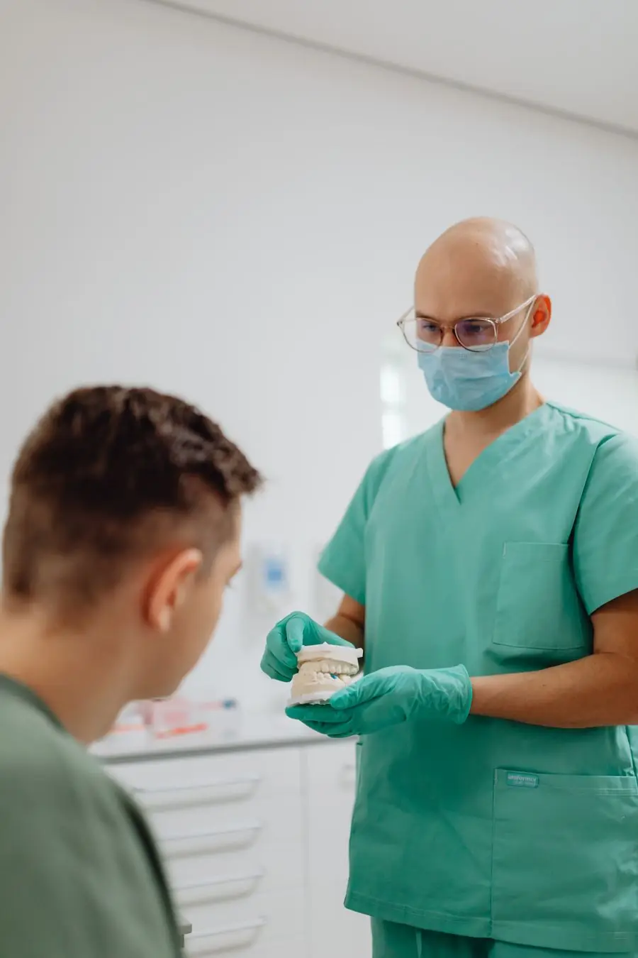 Dentist discussing treatment with a patient in the clinic