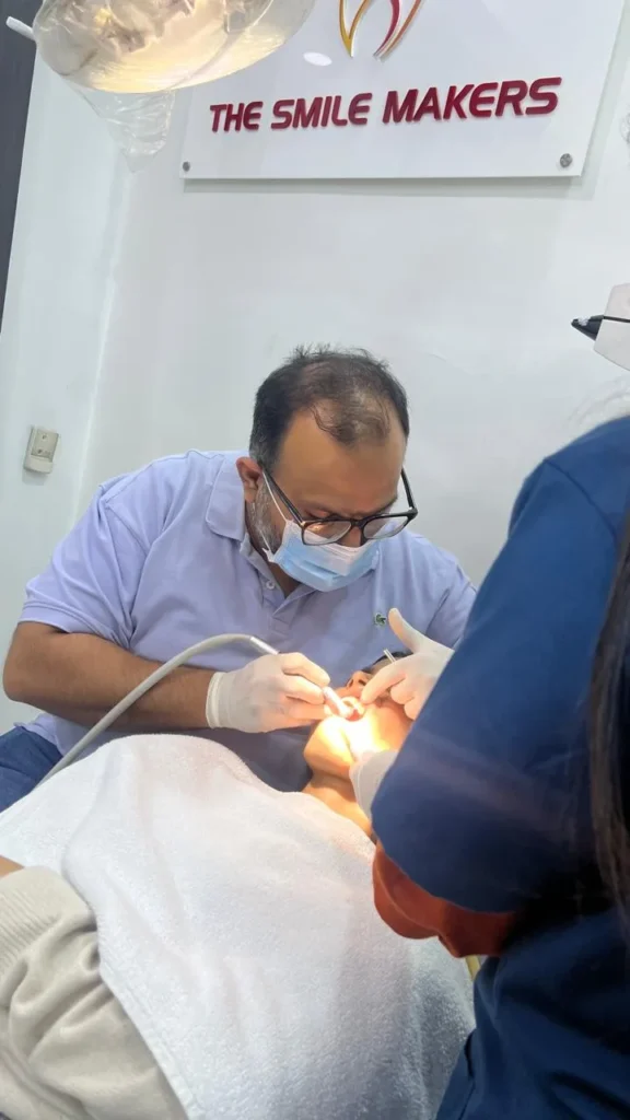Dr. Mohit Bodhwani (Endodontist) during a dental procedure at The Smile Makers Dental Clinic