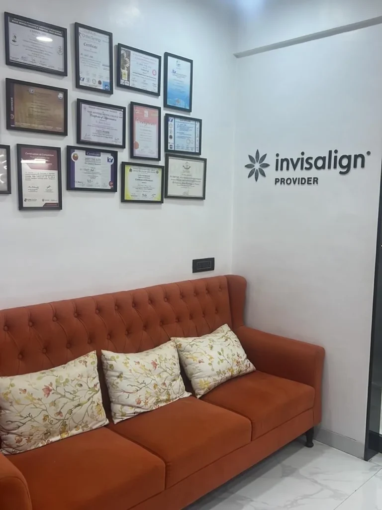Waiting area with Invisalign Provider sign and clinic certificates at The Smile Makers Dental Clinic