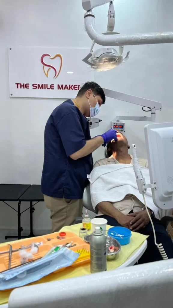 Dentist performing a procedure at The Smile Makers Dental Clinic
